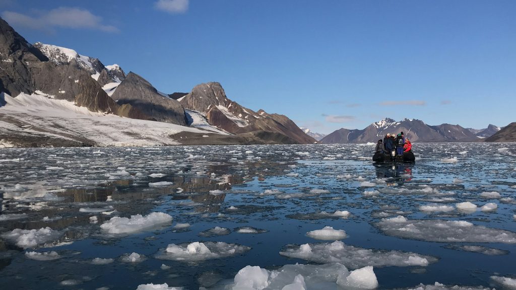 A boat in the centre of an icy bay. Spitsbergen, Svalbard, Svalbard and Jan Mayen