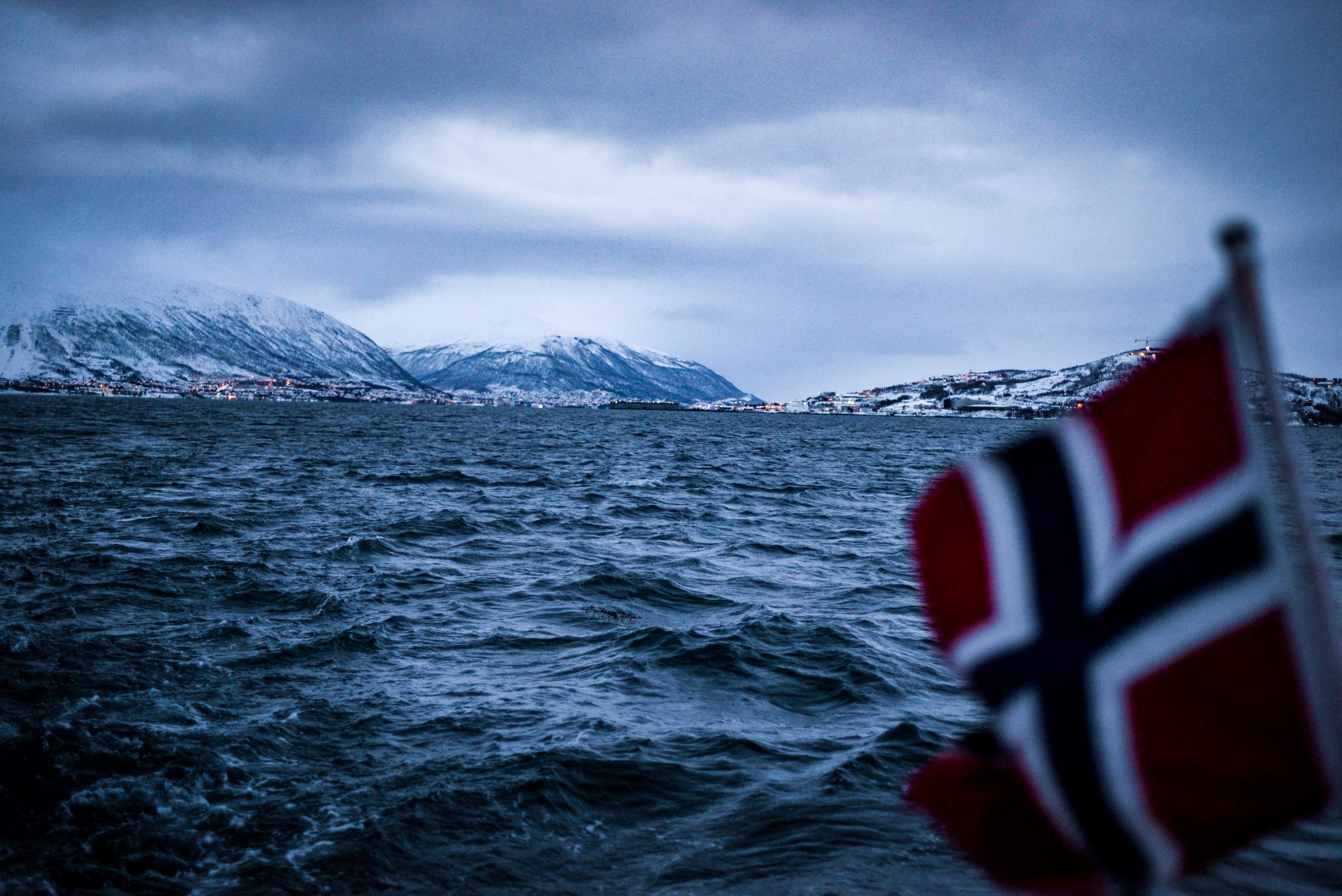 Arctic ocean with Norwegian Flag out of foucs attached to a boat